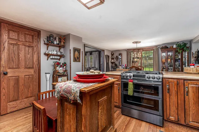 a view of a patio with table and chairs potted plants with wooden fence