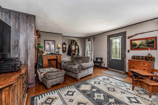 a front view of house with yard and trees around