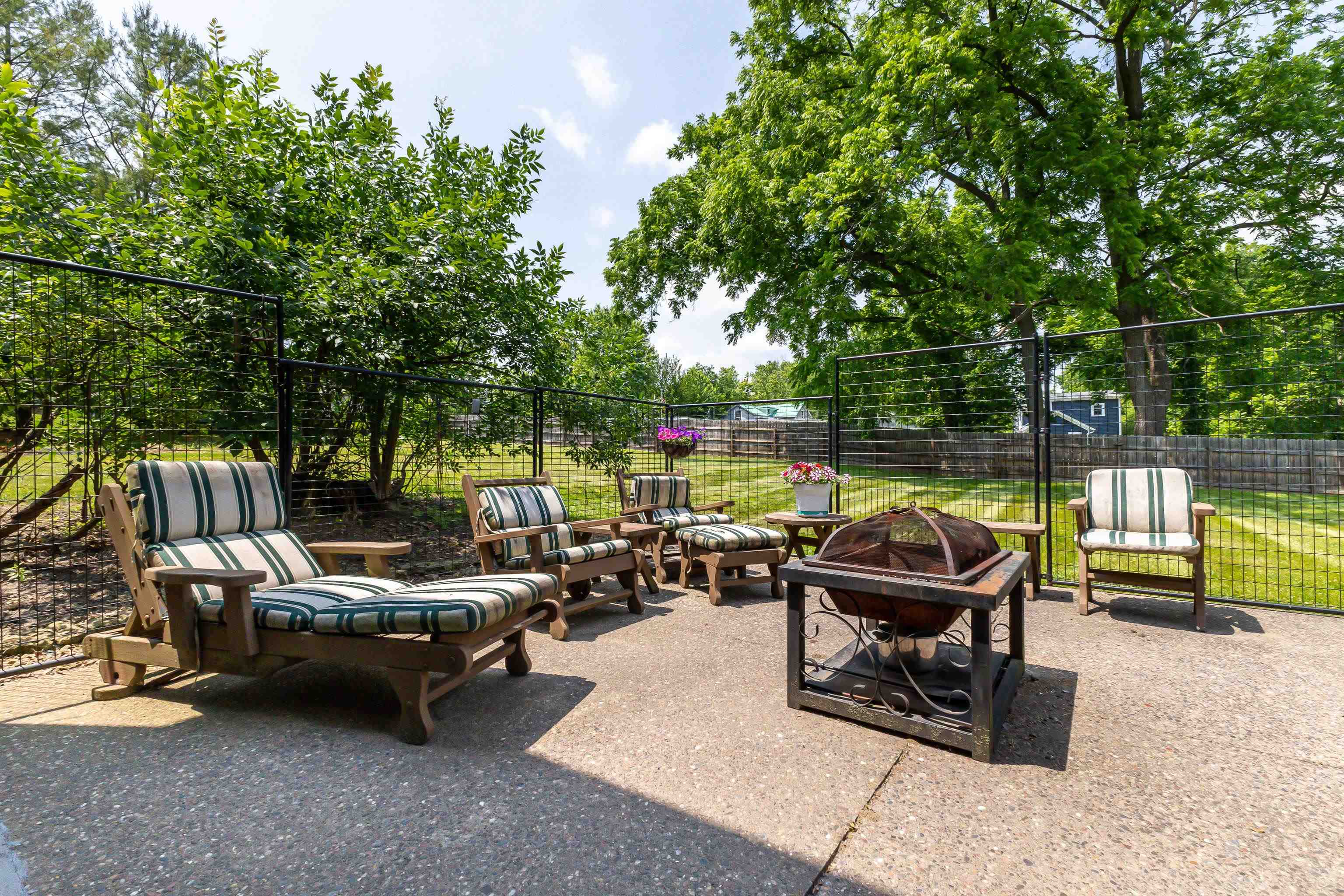 103 4th Street Galena, IL 61036 - Photo 40 of 64 a view of a patio with table and chairs potted plants with wooden fence