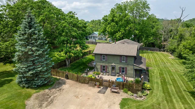 a view of a house with pool and a yard