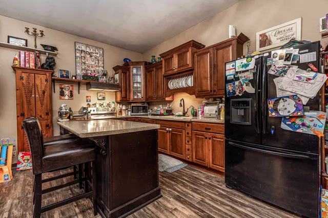 an aerial view of residential house with outdoor space and trees all around