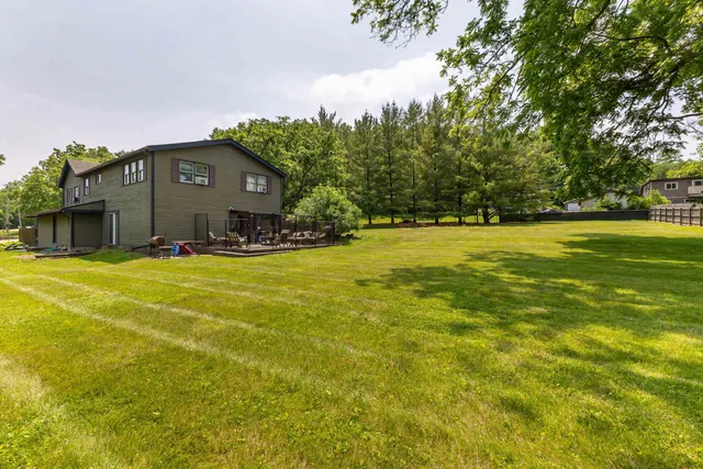 a house view with a wooden fence and trees