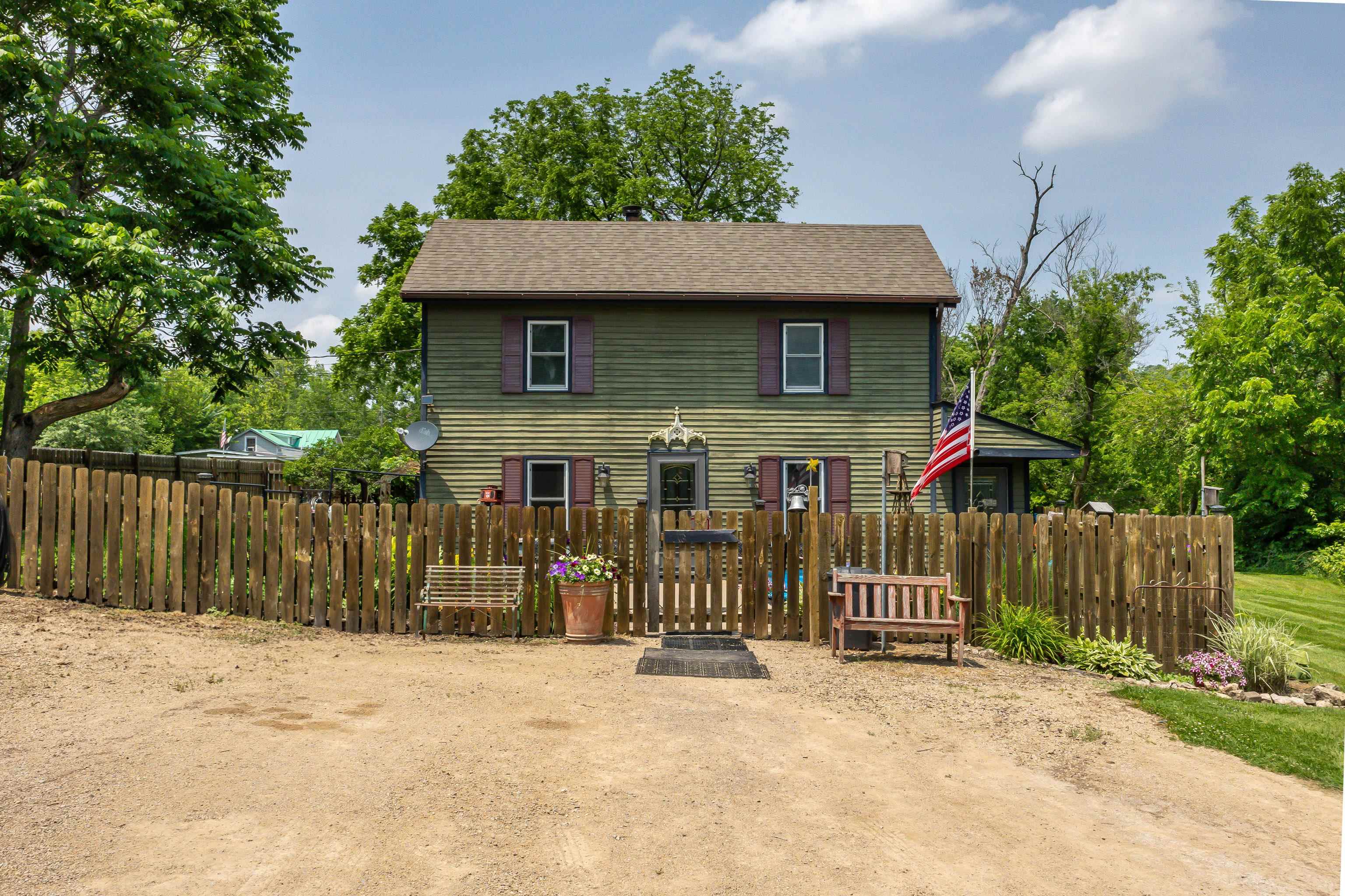 103 4th Street Galena, IL 61036 - Photo 10 of 64 a house view with a wooden fence and trees
