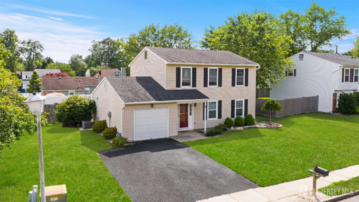 a aerial view of a house next to a big yard and large trees