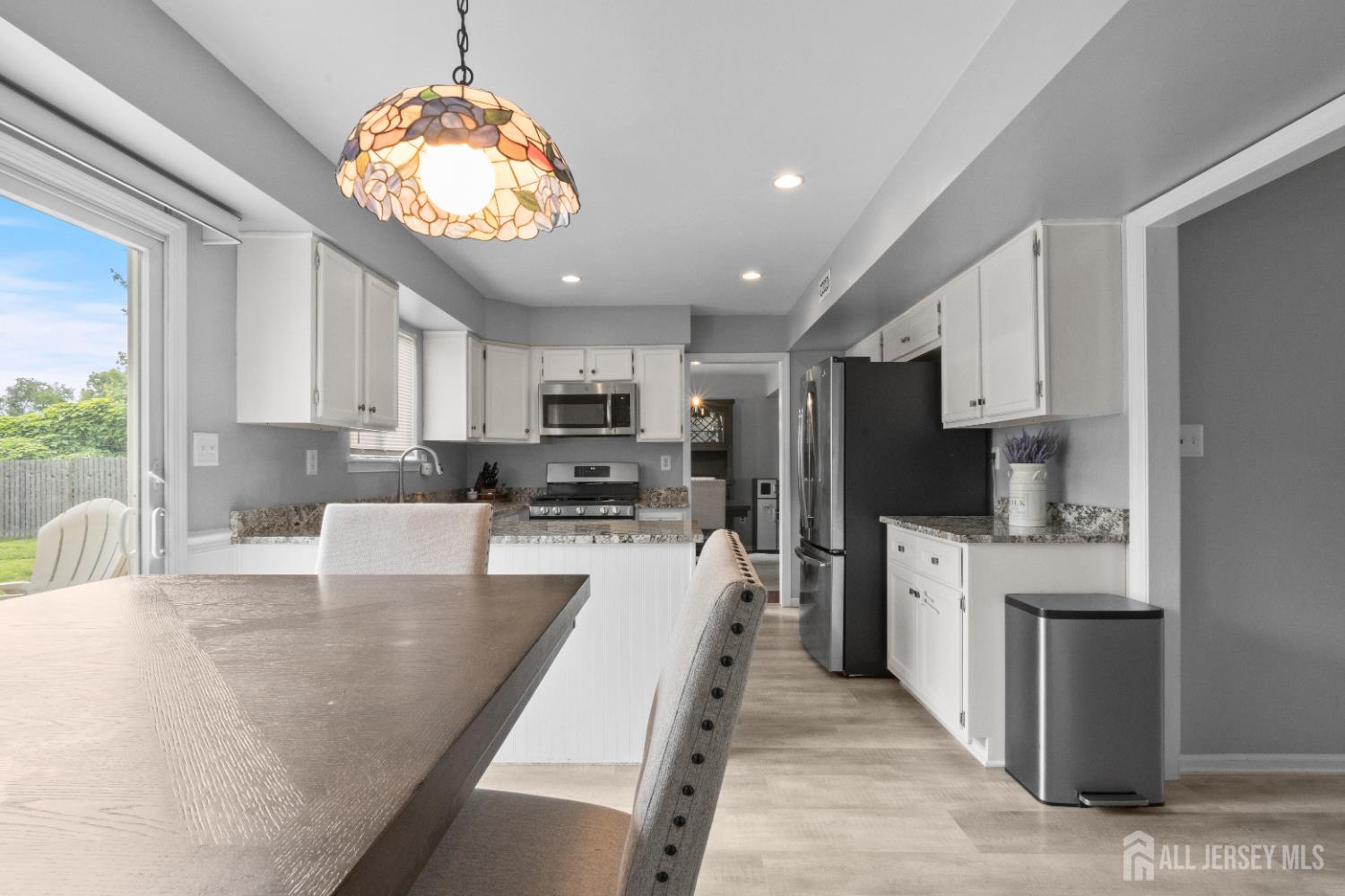3 Mendon Drive Howell, NJ 07731 - Photo 11 of 23 a large kitchen with stainless steel appliances lots of counter space and window