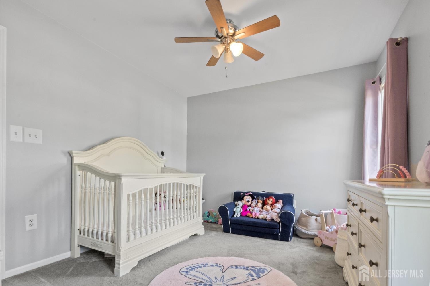 3 Mendon Drive Howell, NJ 07731 - Photo 18 of 23 a bedroom with a bed and a chandelier