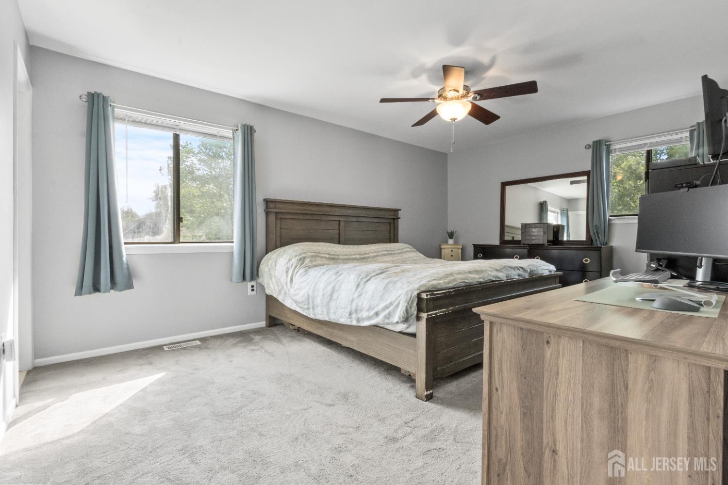 3 Mendon Drive Howell, NJ 07731 - Photo 23 of 23 a bedroom with a large bed and a chandelier