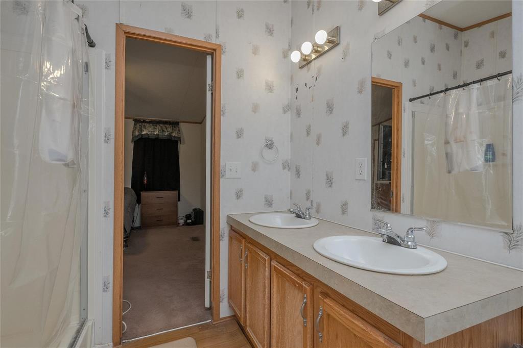 4260 Couch Road Ponder, TX 76259 - Photo 11 of 25 a bathroom with a sink double vanity and a mirror