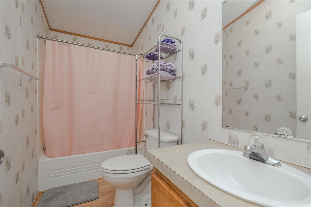 4260 Couch Road Ponder, TX 76259 - Photo 14 of 25 a bathroom with a sink a toilet and shower