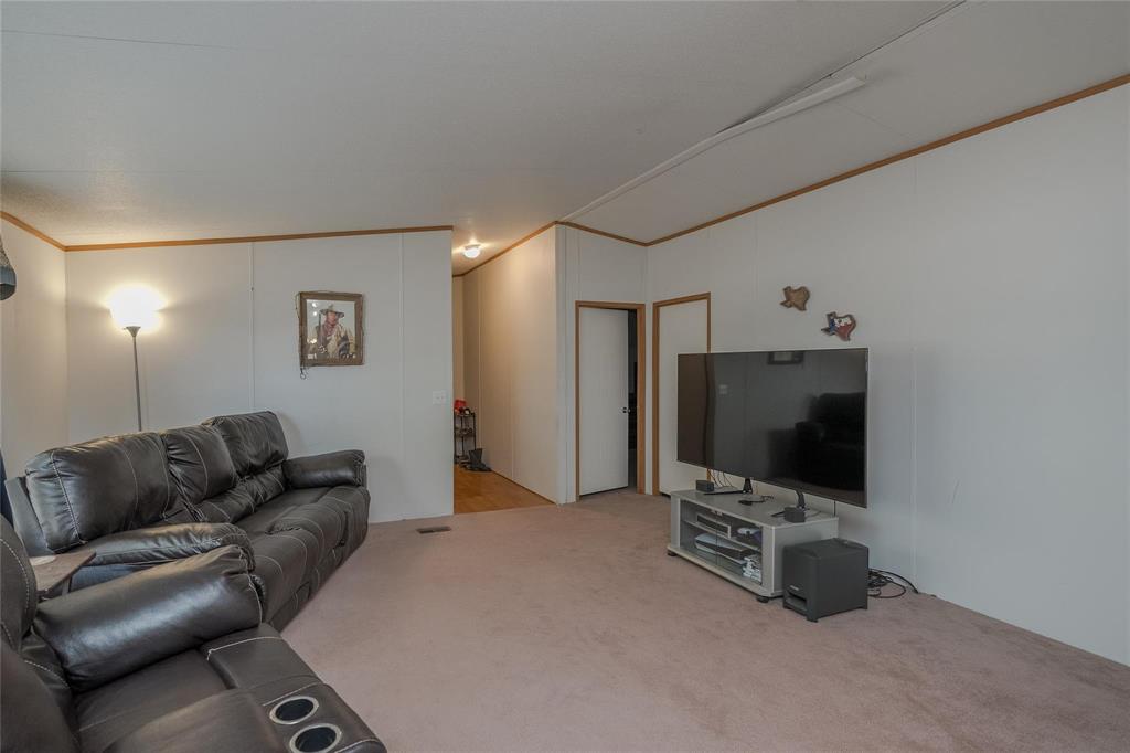 4260 Couch Road Ponder, TX 76259 - Photo 16 of 25 a living room with furniture and a flat screen tv