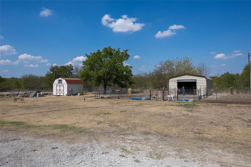 4260 Couch Road Ponder, TX 76259 - Photo 6 of 25 a front view of a house with a yard and garage