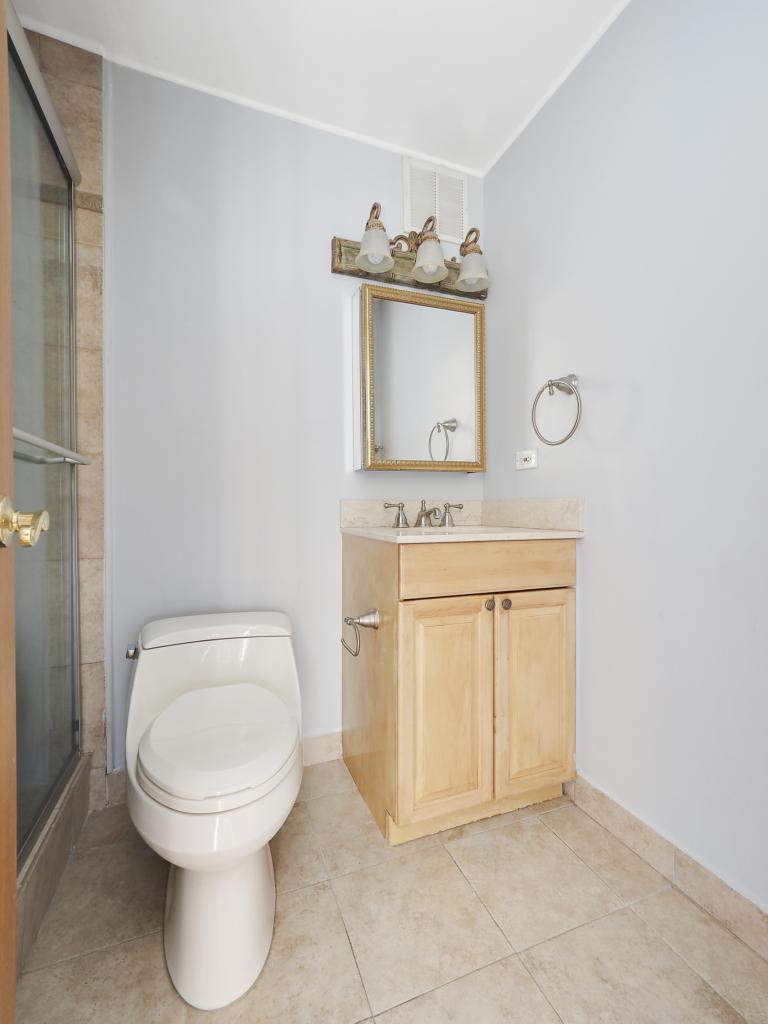 100 East Walton Street, Unit 27B Chicago, IL 60611 - Photo 13 of 18 a bathroom with a toilet sink and vanity