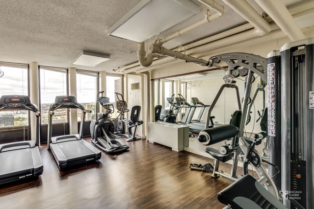 100 East Walton Street, Unit 27B Chicago, IL 60611 - Photo 16 of 18 a view of a room with gym equipment