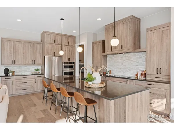 a kitchen with kitchen island granite countertop a sink cabinets and stainless steel appliances