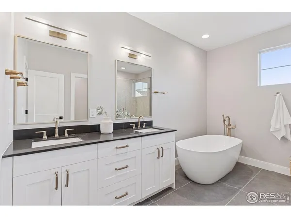 a spacious bathroom with a double vanity sink and a mirror