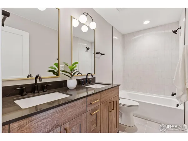 a bathroom with a sink a double vanity and a mirror