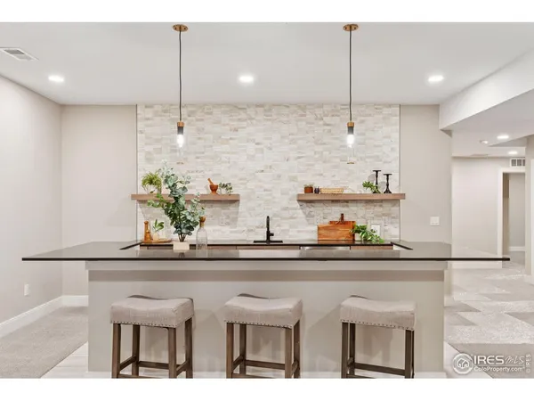 a kitchen with stainless steel appliances kitchen island granite countertop a table and chairs in it