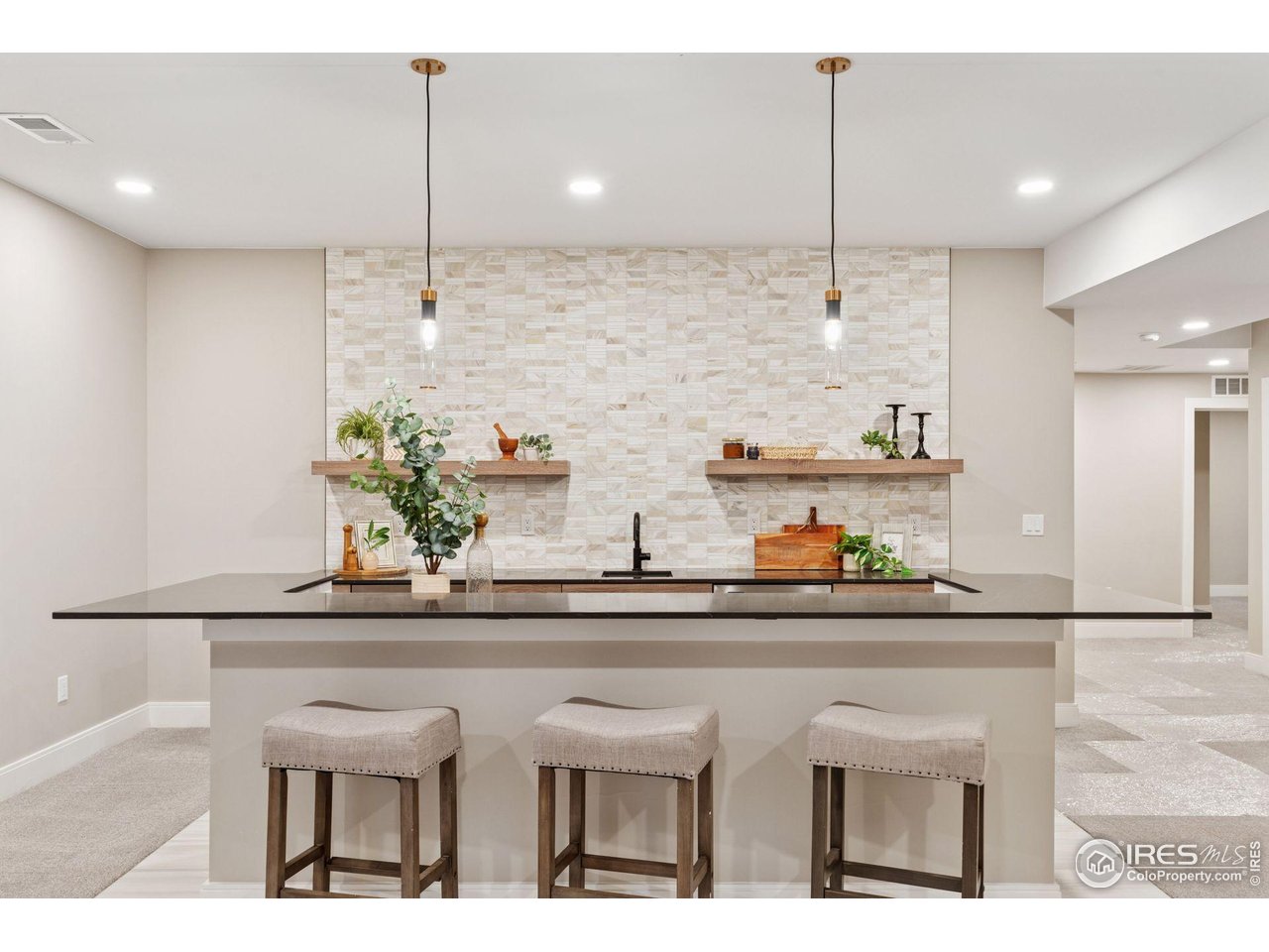 927 William Way Berthoud, CO 80513 - Photo 21 of 28 a kitchen with stainless steel appliances kitchen island granite countertop a table and chairs in it