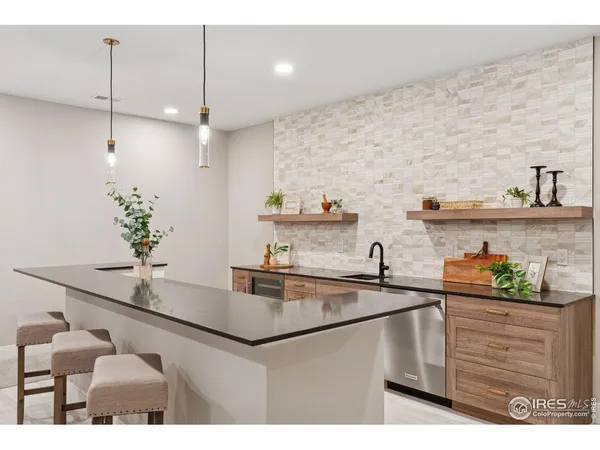 a kitchen with kitchen island stainless steel appliances a sink and cabinets