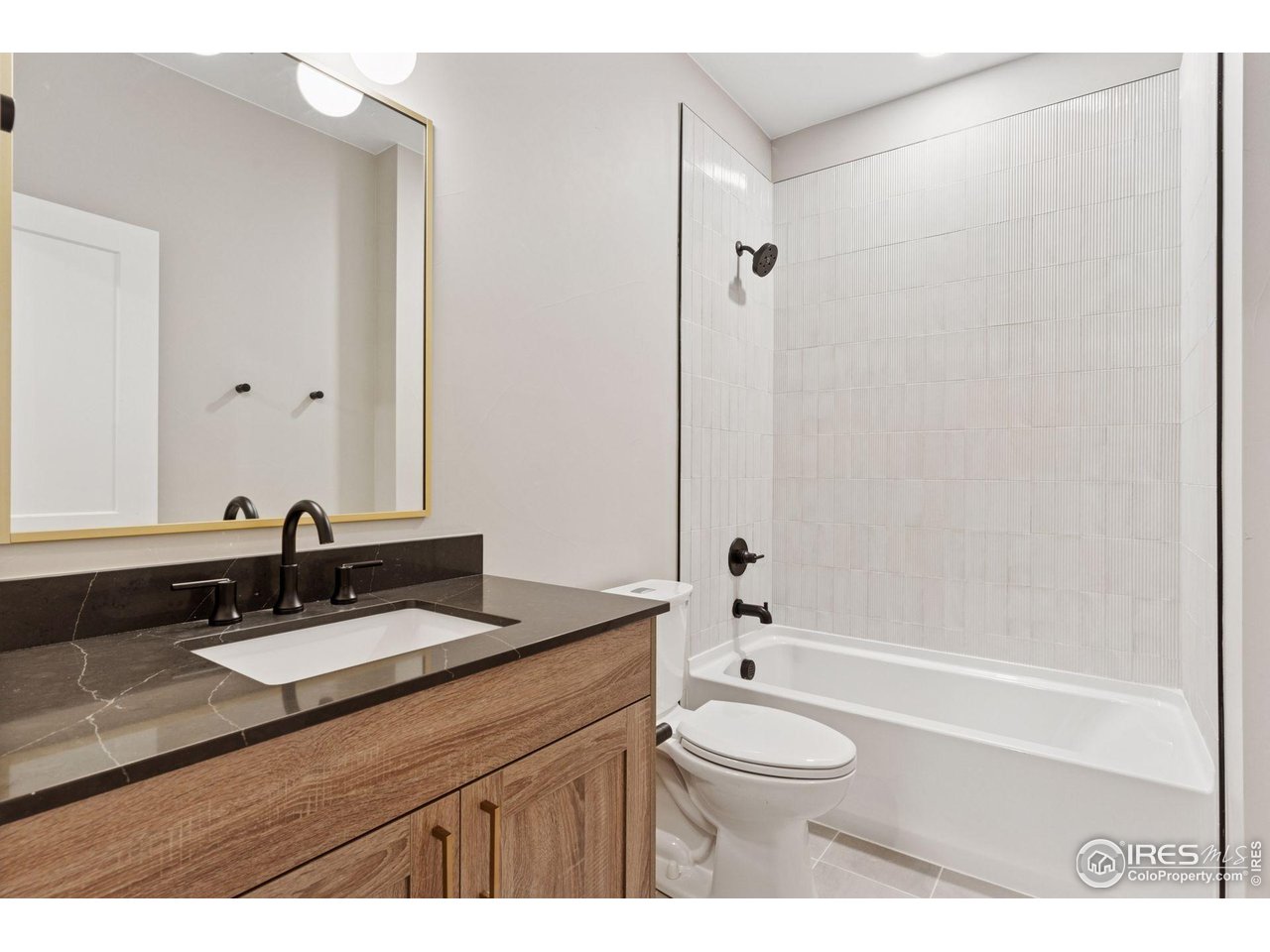 927 William Way Berthoud, CO 80513 - Photo 24 of 28 a bathroom with a granite countertop sink a toilet a mirror and shower