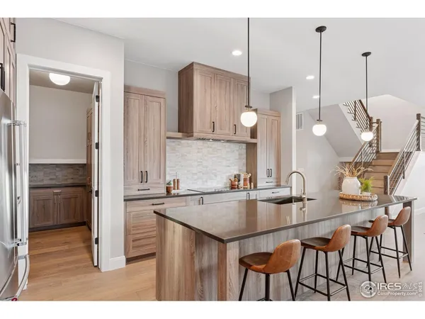 a kitchen with kitchen island a counter top space appliances and cabinets