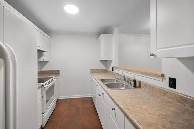 a kitchen with a sink stove and refrigerator
