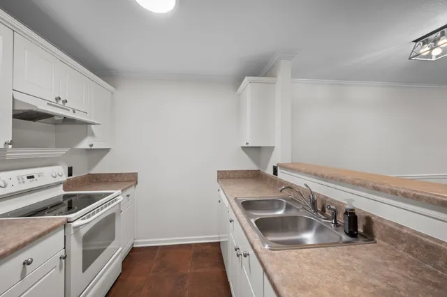 a kitchen that has a sink and a stove