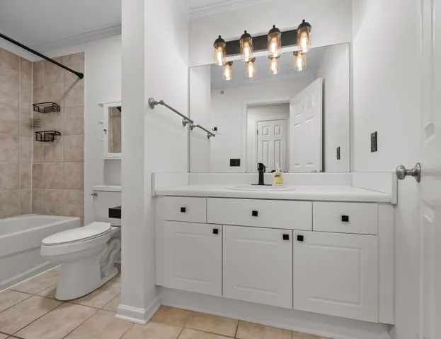 a bathroom with a double vanity sink mirror and toilet