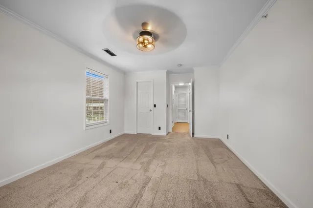a view of a room with a window and a ceiling fan
