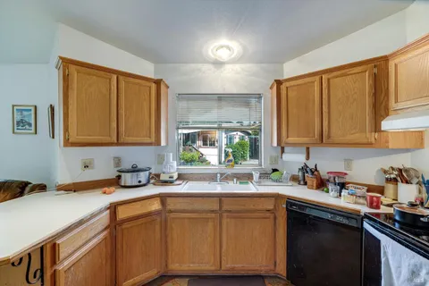a kitchen with a sink cabinets and window