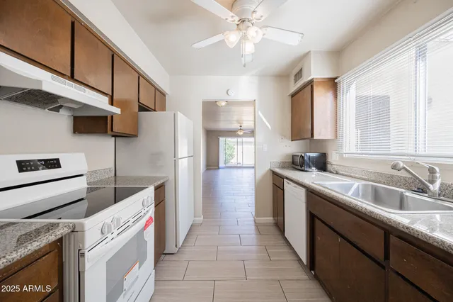a kitchen with a sink cabinets and window