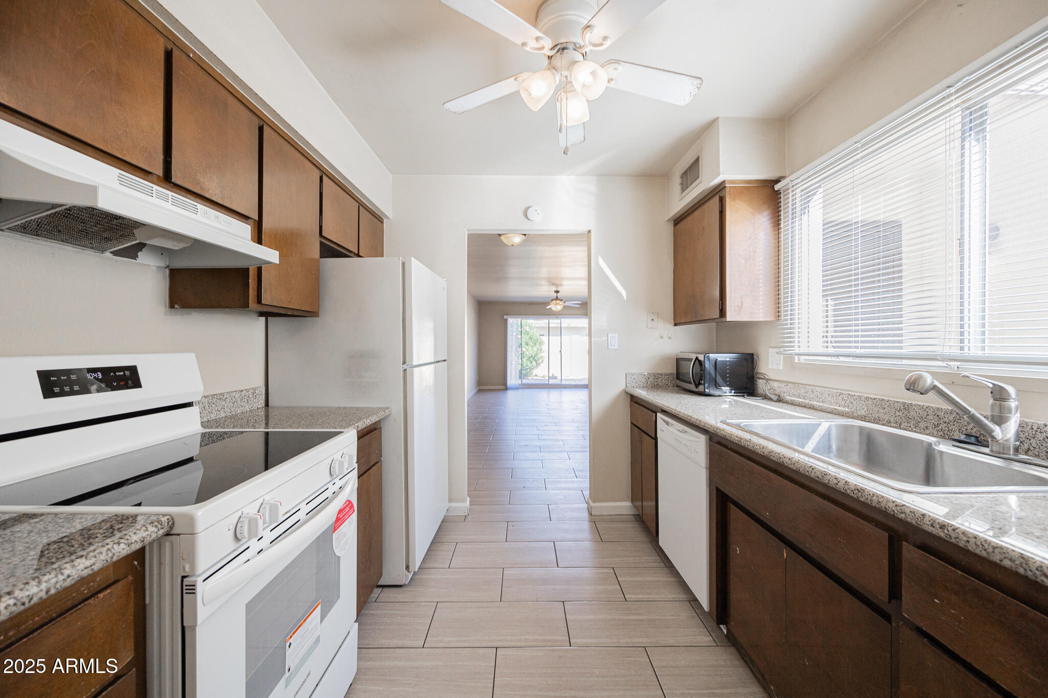 2724 South Azalea Drive Tempe, AZ 85282 - Photo 11 of 25 a kitchen with a sink cabinets and window