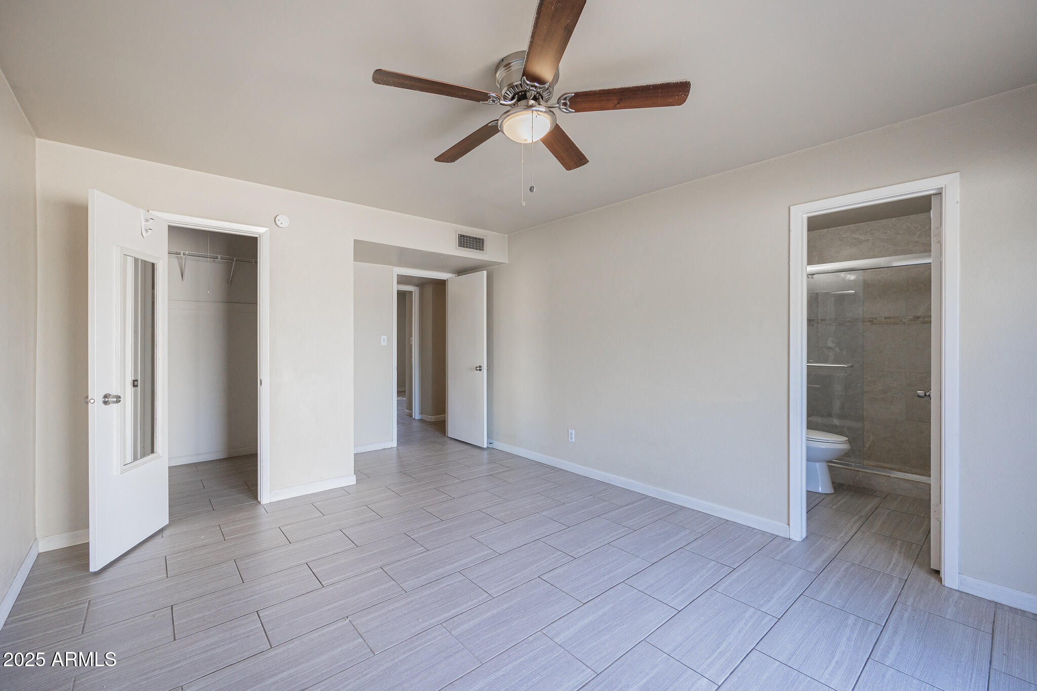 2724 South Azalea Drive Tempe, AZ 85282 - Photo 13 of 25 a view of a livingroom with a ceiling fan and a bathroom