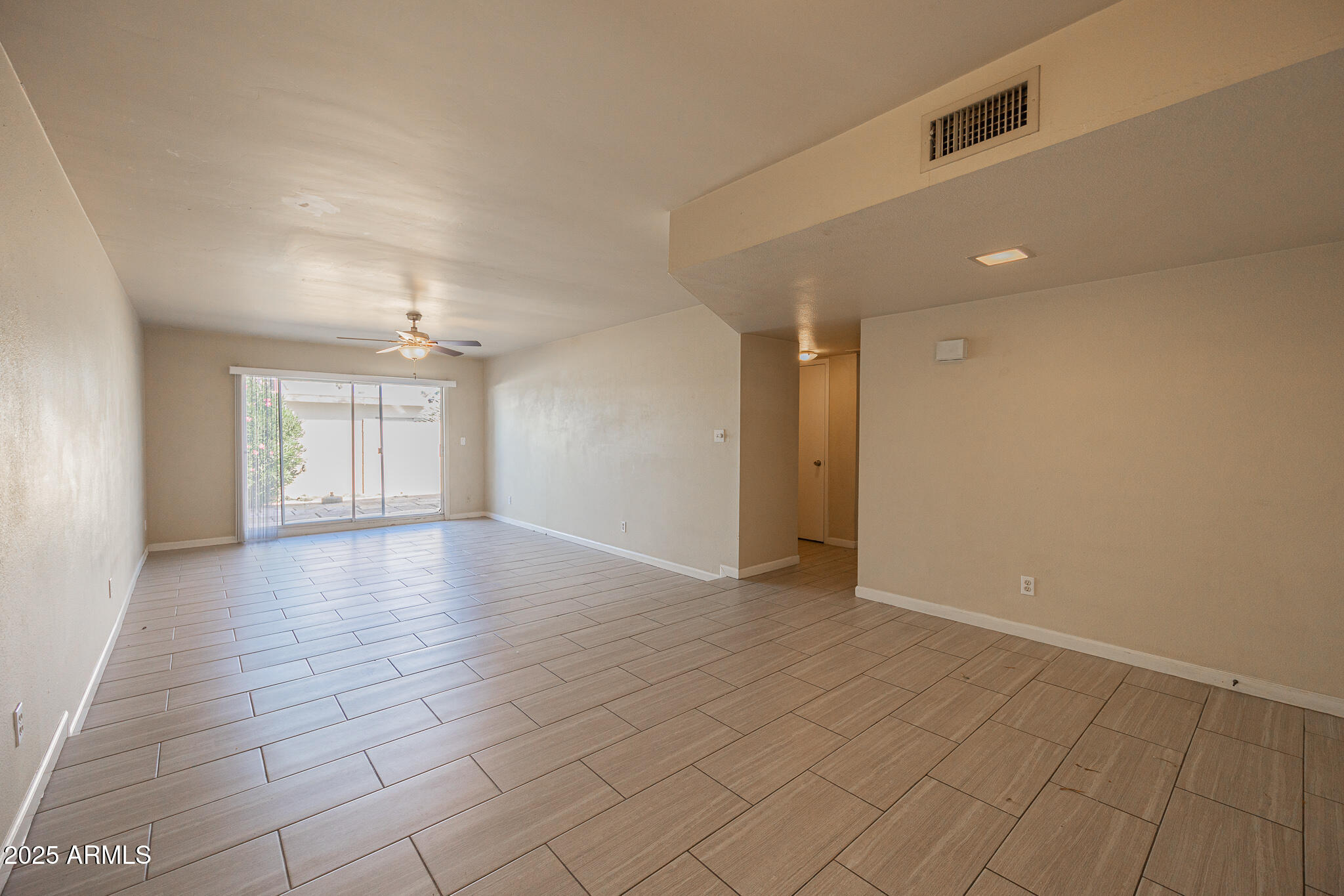 2724 South Azalea Drive Tempe, AZ 85282 - Photo 4 of 25 wooden floor in an empty room with a window
