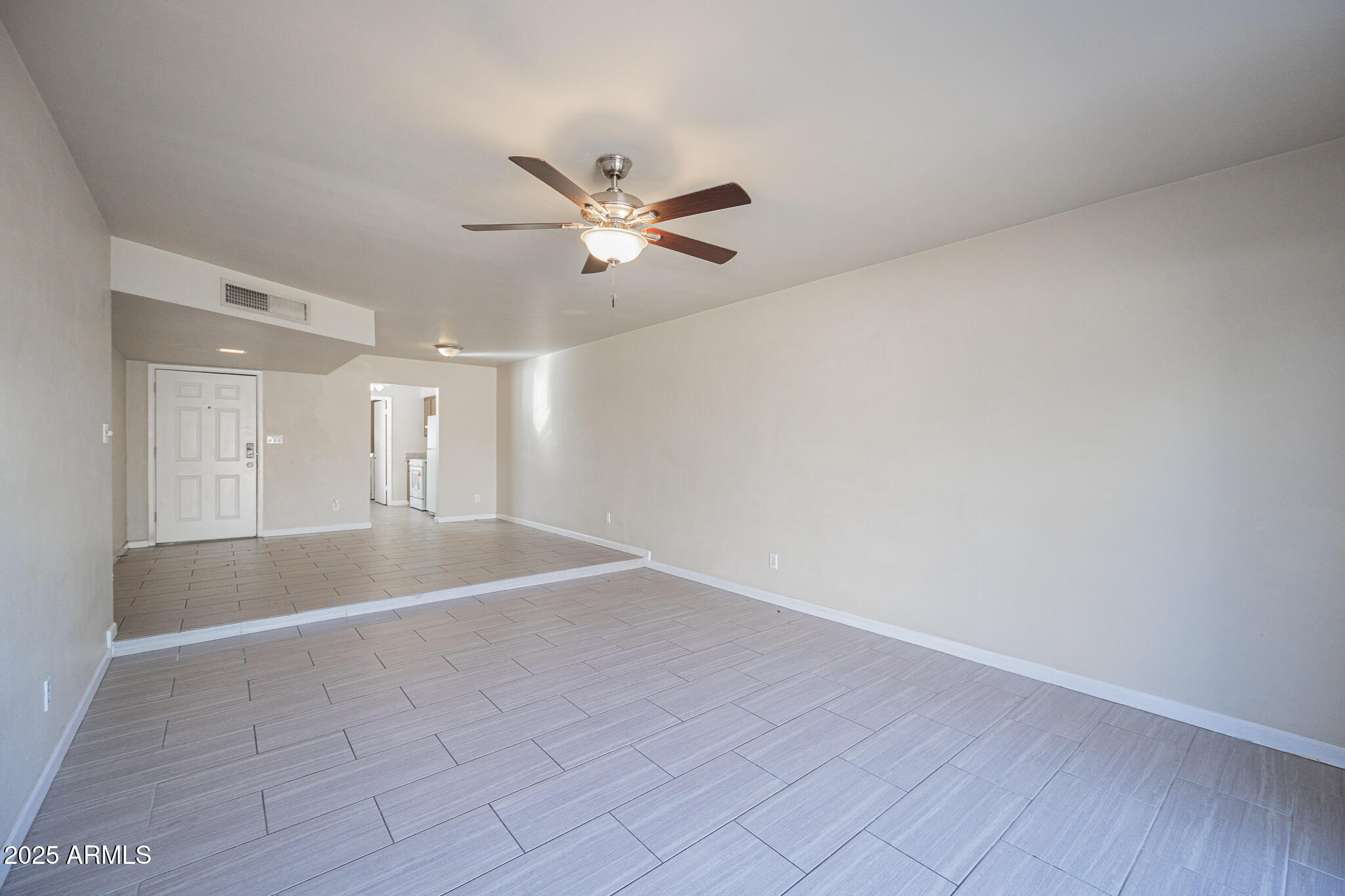 2724 South Azalea Drive Tempe, AZ 85282 - Photo 7 of 25 a view of empty room with wooden floor and fan