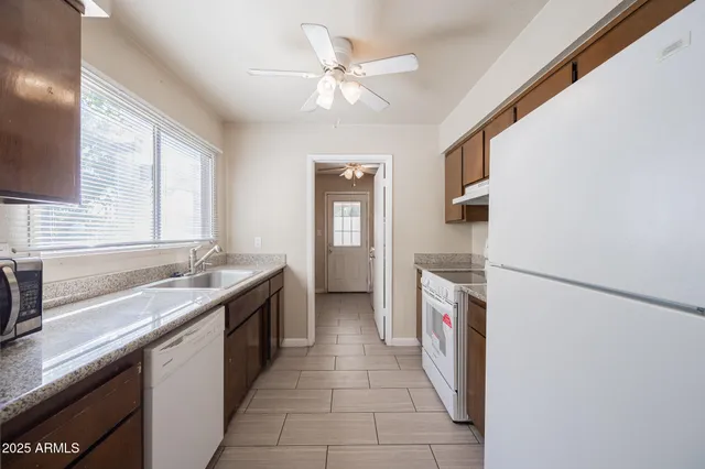 a kitchen with a sink stove and refrigerator