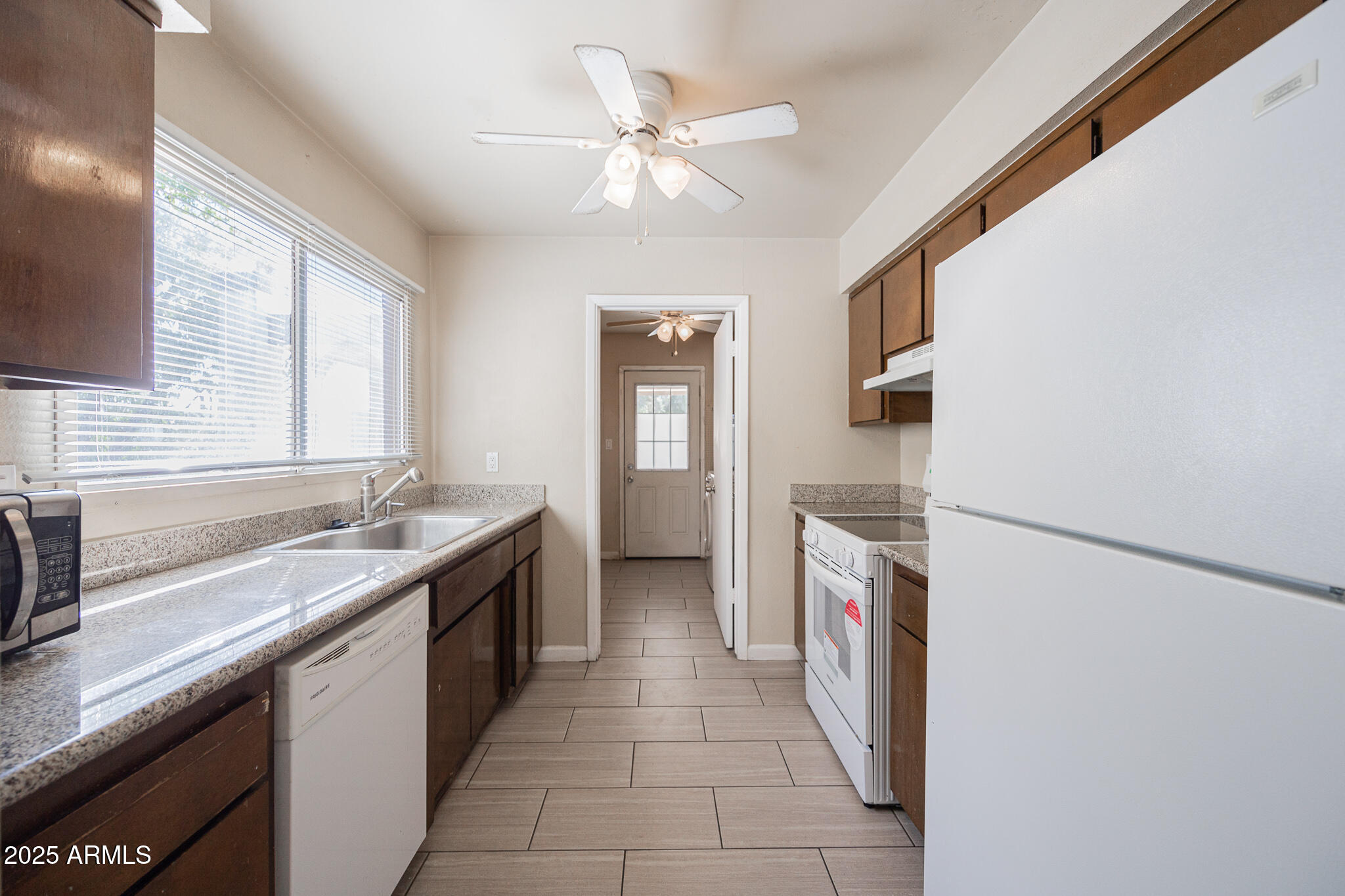 2724 South Azalea Drive Tempe, AZ 85282 - Photo 9 of 25 a kitchen with a sink stove and refrigerator