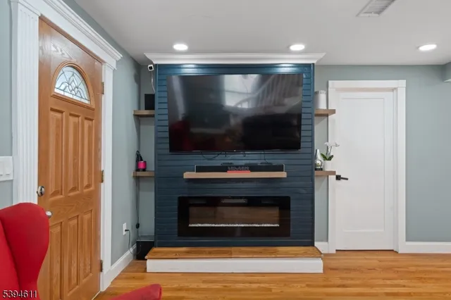 a living room with a flat screen tv and a fireplace