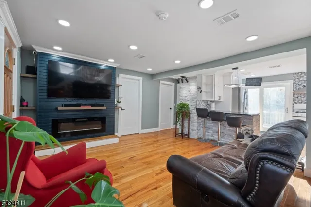 a living room with furniture and a flat screen tv