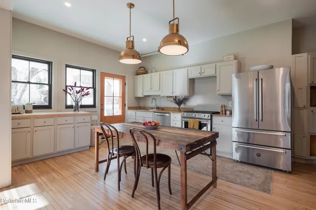 a kitchen with stainless steel appliances granite countertop a sink dishwasher stove and refrigerator