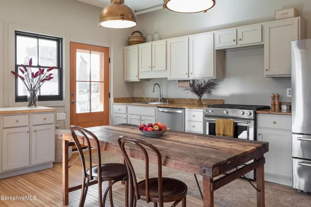 a kitchen with stainless steel appliances granite countertop a refrigerator sink and cabinets
