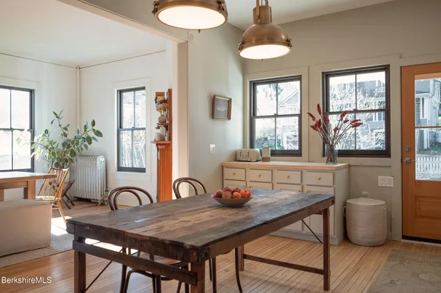 a living room with furniture potted plant and kitchen view