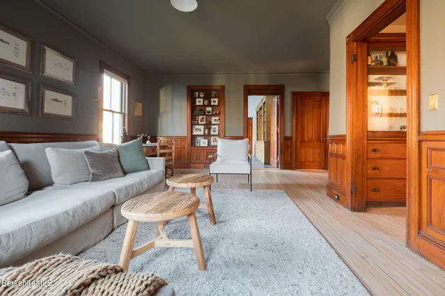 a spacious bedroom with a bed a mirror and furniture