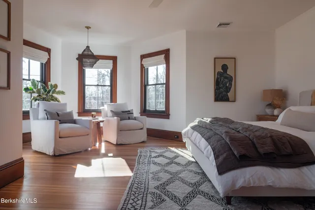 a bedroom with furniture and a closet