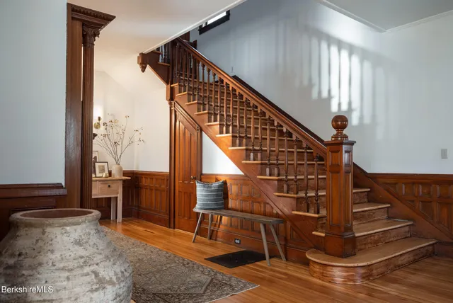 a living room with furniture a fireplace and a rug