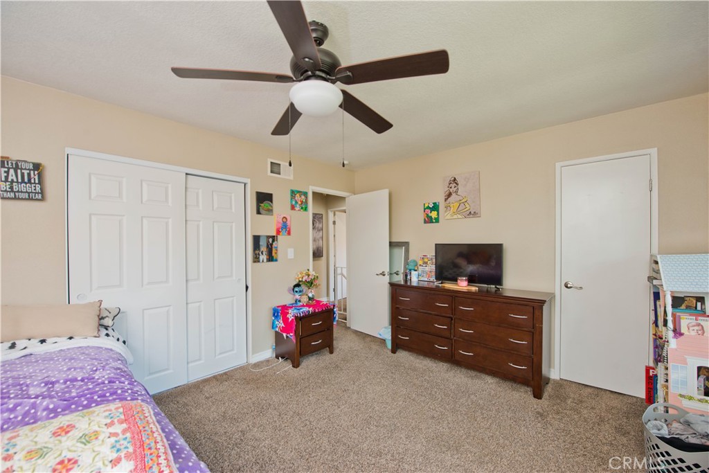 1124 Okapi Lane Ventura, CA 93003 - Photo 17 of 22 a bedroom with a bed and a tv in it