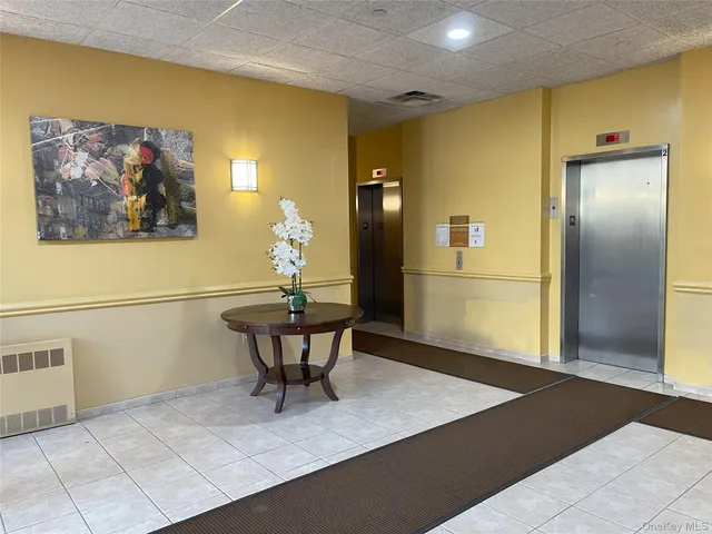 a white kitchen with a sink a stove and a microwave