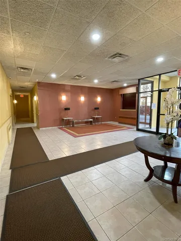 a lobby with a table and chairs