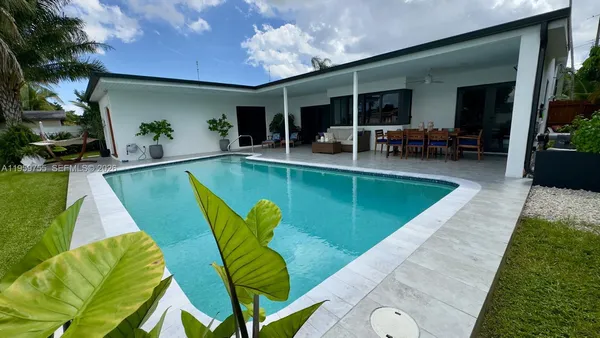 a view of a swimming pool with chairs