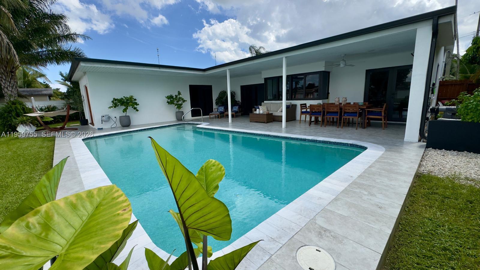 a view of a swimming pool with chairs